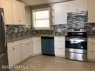 5122 Birkenhead Road Jacksonville, FL 32210 - Photo 12 of 31 a kitchen with granite countertop white cabinets and stainless steel appliances