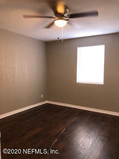 5122 Birkenhead Road Jacksonville, FL 32210 - Photo 17 of 31 en empty room with wooden floor and windows