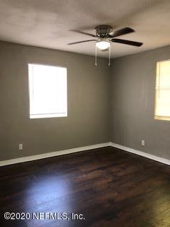 5122 Birkenhead Road Jacksonville, FL 32210 - Photo 21 of 31 an empty room with wooden floor and windows
