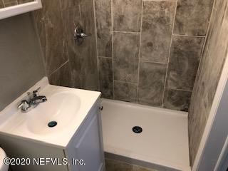 5122 Birkenhead Road Jacksonville, FL 32210 - Photo 26 of 31 a bathroom with a sink and mirror