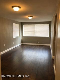 5122 Birkenhead Road Jacksonville, FL 32210 - Photo 28 of 31 an empty room with wooden floor and windows
