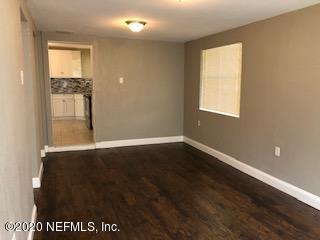 5122 Birkenhead Road Jacksonville, FL 32210 - Photo 30 of 31 an empty room with wooden floor and windows
