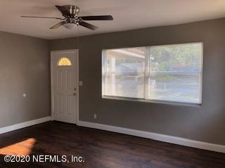 5122 Birkenhead Road Jacksonville, FL 32210 - Photo 5 of 31 a view of an empty room with wooden floor and a window
