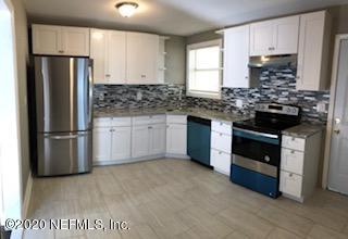 5122 Birkenhead Road Jacksonville, FL 32210 - Photo 7 of 31 a kitchen with a stove and a refrigerator