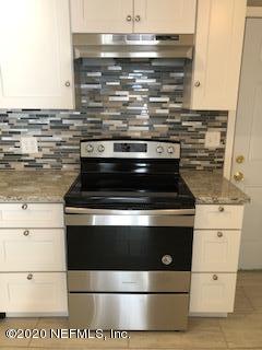 5122 Birkenhead Road Jacksonville, FL 32210 - Photo 8 of 31 a stove top oven sitting inside of a kitchen