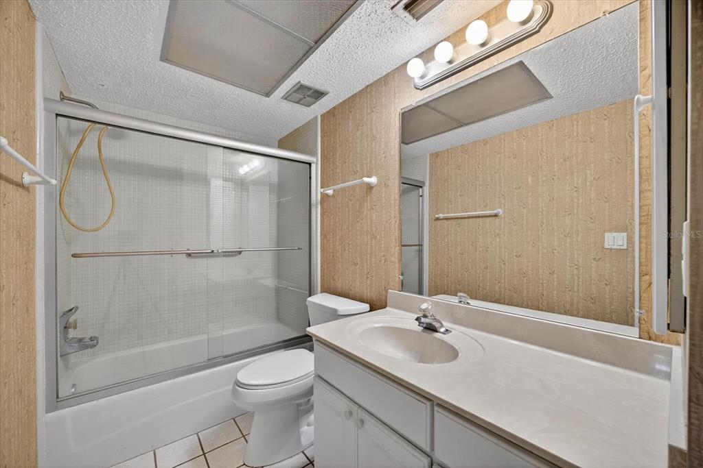 1701 Pinehurst Road, Unit 36C Dunedin, FL 34698 - Photo 13 of 25 a bathroom with a sink a toilet and shower