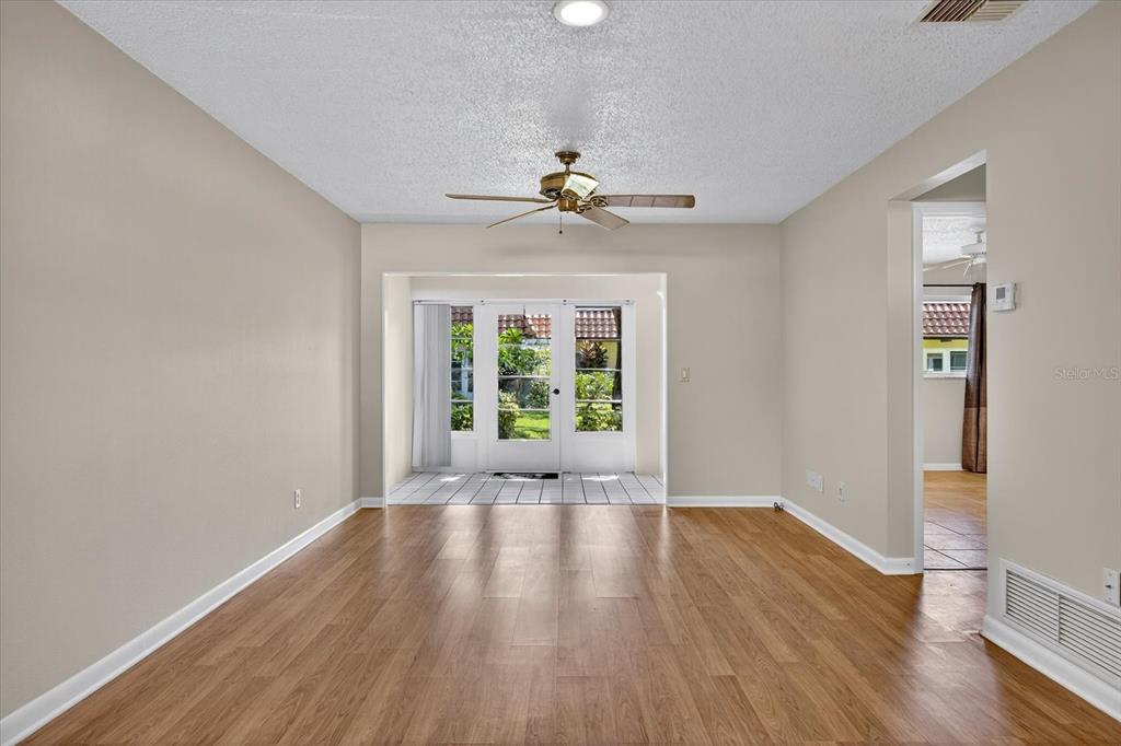 1701 Pinehurst Road, Unit 36C Dunedin, FL 34698 - Photo 4 of 25 a view of an empty room with wooden floor and a window