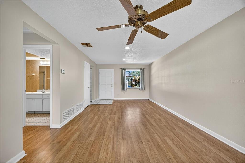 1701 Pinehurst Road, Unit 36C Dunedin, FL 34698 - Photo 5 of 25 wooden floor in an empty room with a window