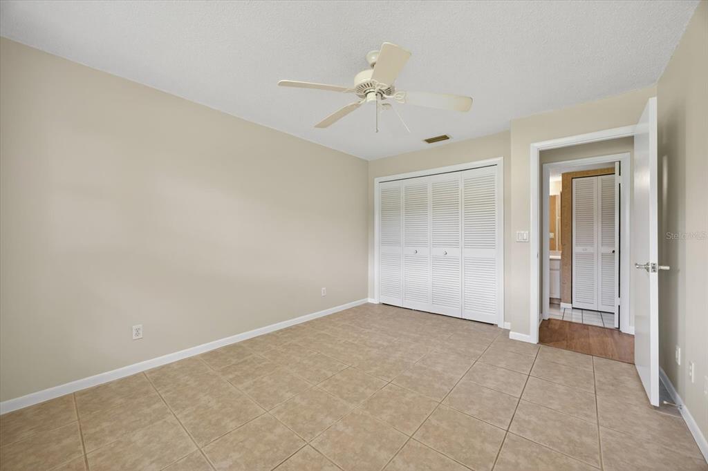 1701 Pinehurst Road, Unit 36C Dunedin, FL 34698 - Photo 10 of 25 a view of an empty room with a chandelier fan