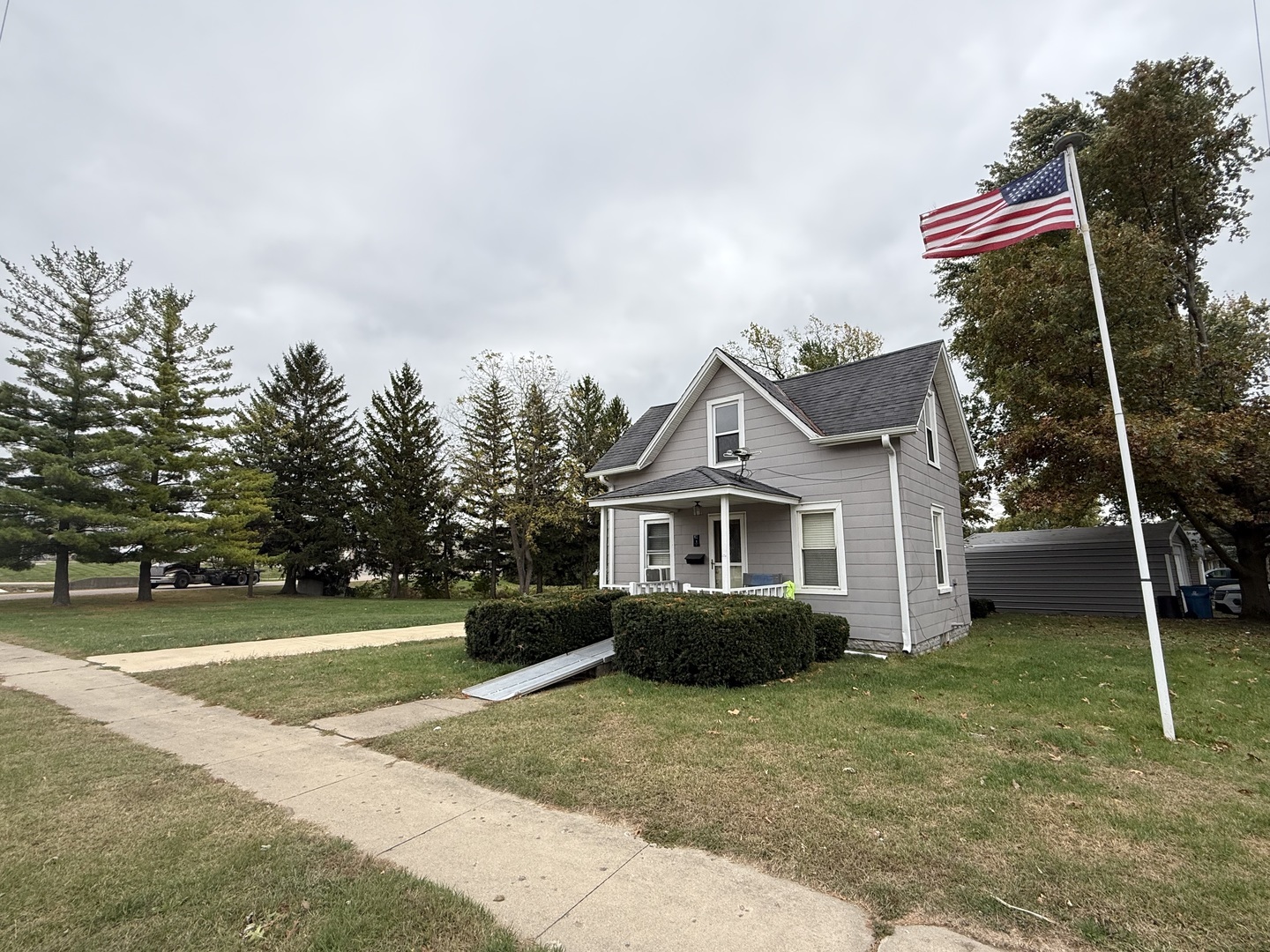 1 East Main Street Amboy, IL 61310 - Photo 1 of 32 a front view of a house with a yard and trees