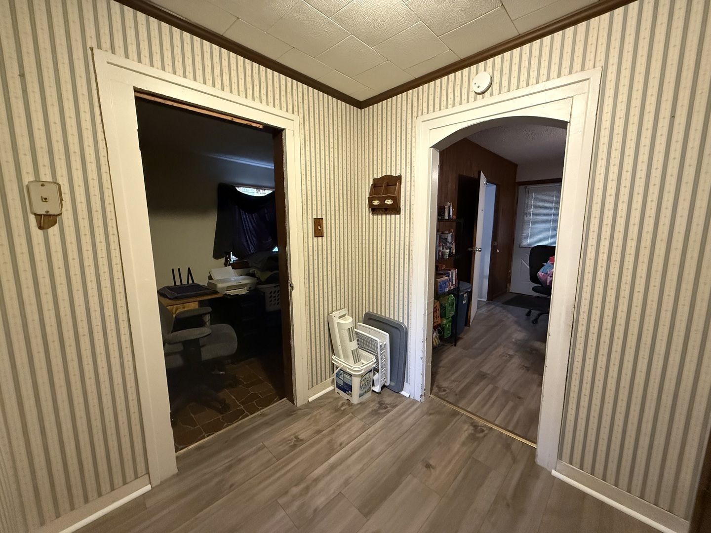 1 East Main Street Amboy, IL 61310 - Photo 26 of 32 a view of a hallway and a livingroom with wooden floor and furniture