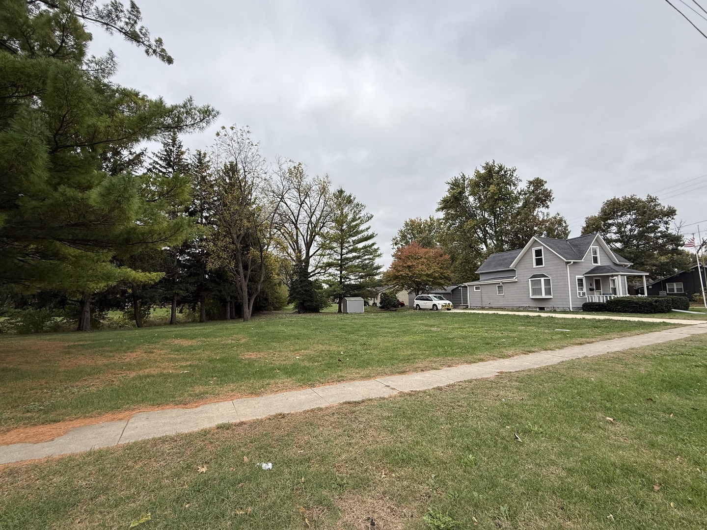 1 East Main Street Amboy, IL 61310 - Photo 3 of 32 a view of a big room with a big yard and large trees