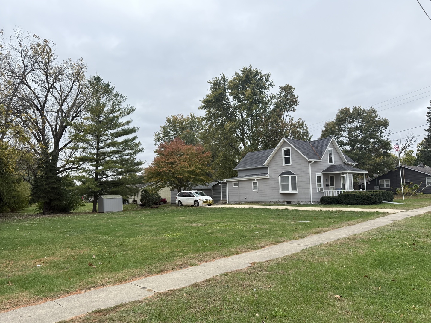 1 East Main Street Amboy, IL 61310 - Photo 4 of 32 a view of a house with a big yard and large trees