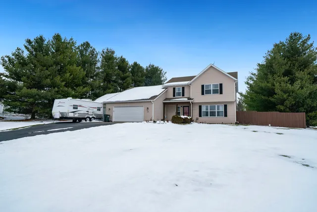 a car parked in front of house with a yard
