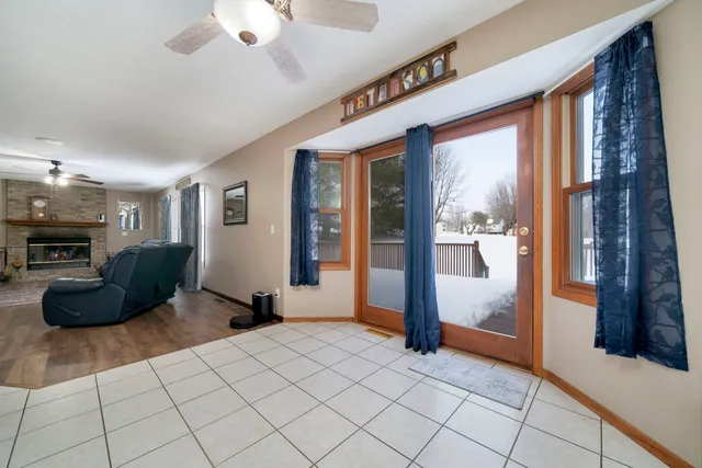 a living room with furniture a dining table and a large window
