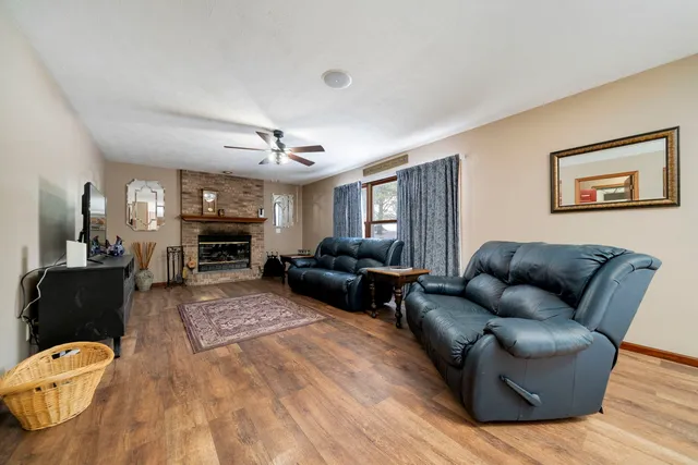 a living room with furniture ceiling fan and a fireplace