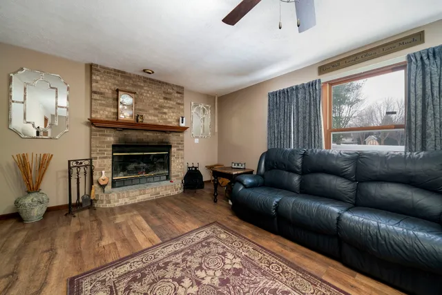a living room with furniture a flat screen tv and a fireplace