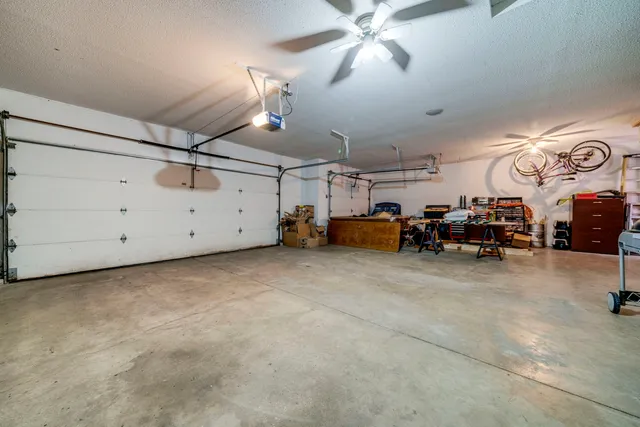 a view of a livingroom with furniture and a fan
