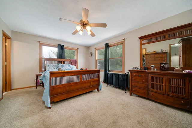 a bedroom with a large bed closet and flat screen tv