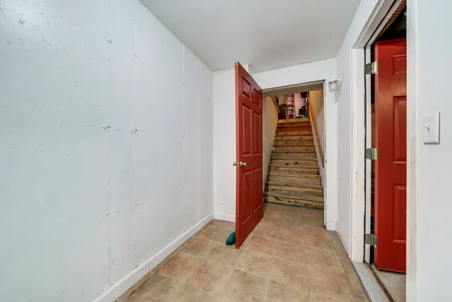 a view of balcony with two trees and wooden fence