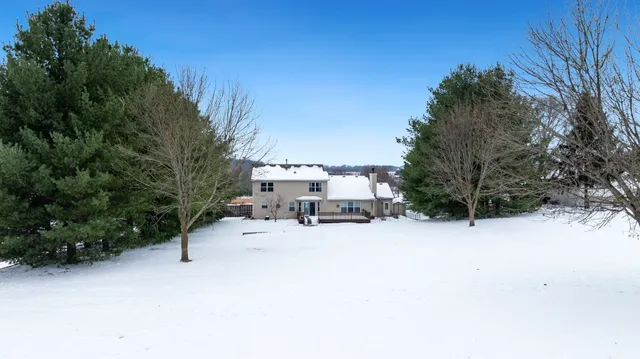 a view of a house with roof deck and sitting area