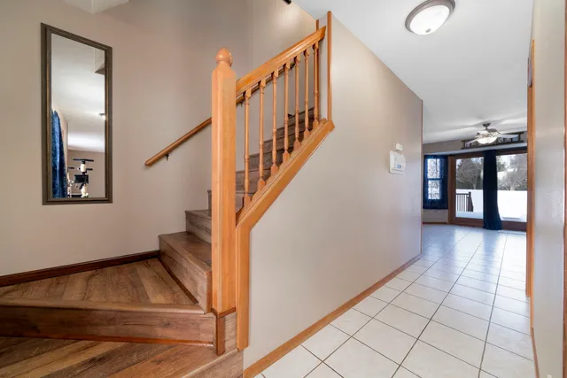 a view of entryway and hall with wooden floor