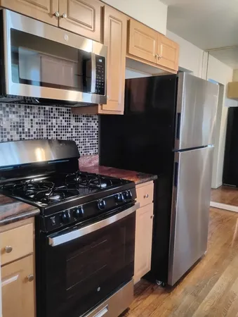 a stove top oven sitting inside of a kitchen