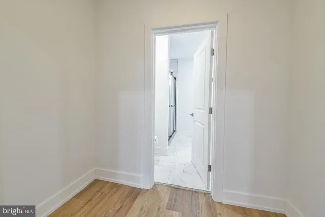 a view of an empty room with wooden floor