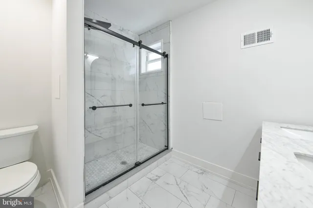 a bathroom with a shower and toilet