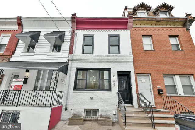 a view of a white building with many windows