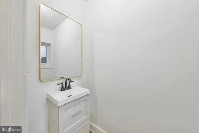 a bathroom with a sink and mirror