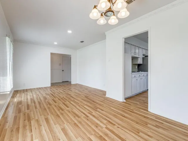 a view of an empty room and wooden floor
