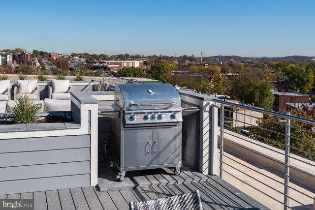 a view of a terrace with a table and chairs