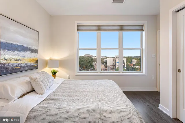 a bedroom with a large bed and a large window