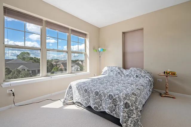 a bedroom with bed and window