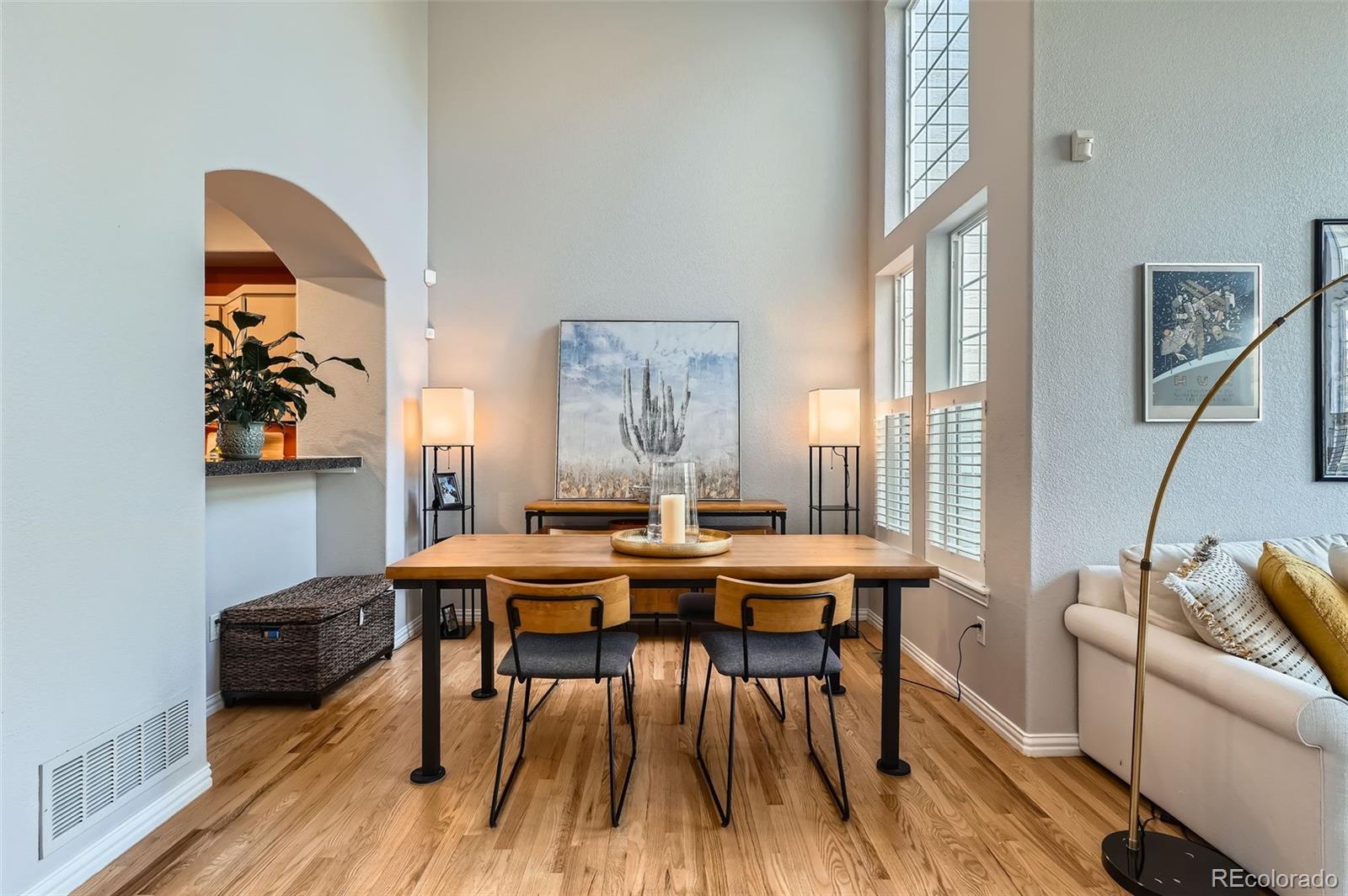 8300 Fairmount Drive, Unit AA102 Denver, CO 80247 - Photo 11 of 27 a view of a dining room with furniture window and wooden floor