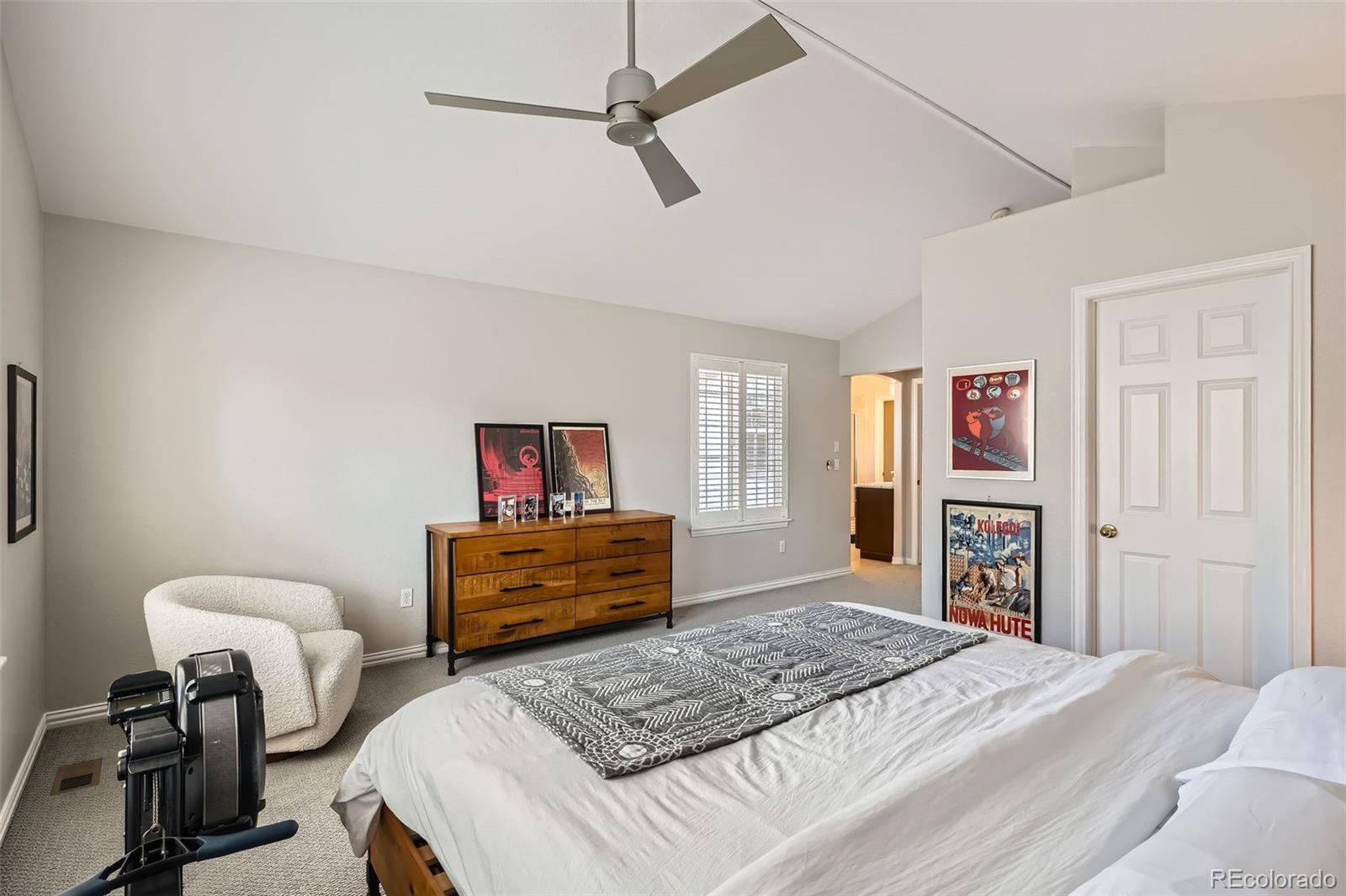 8300 Fairmount Drive, Unit AA102 Denver, CO 80247 - Photo 14 of 27 a bedroom with a bed and a dresser in it