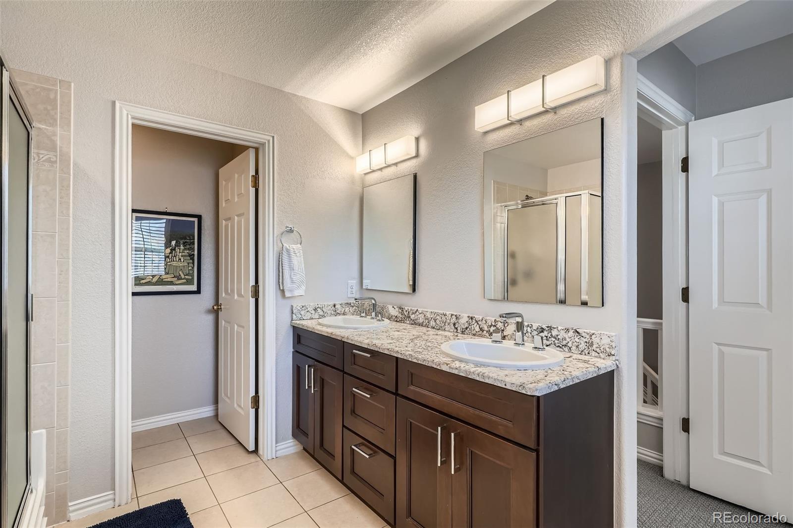 8300 Fairmount Drive, Unit AA102 Denver, CO 80247 - Photo 16 of 27 a bathroom with a sink and a mirror