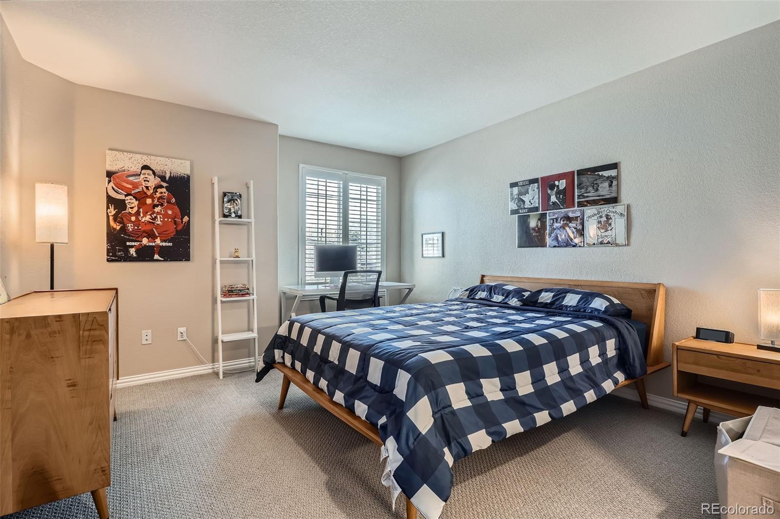 8300 Fairmount Drive, Unit AA102 Denver, CO 80247 - Photo 17 of 27 a bedroom with a bed wall painting and a window