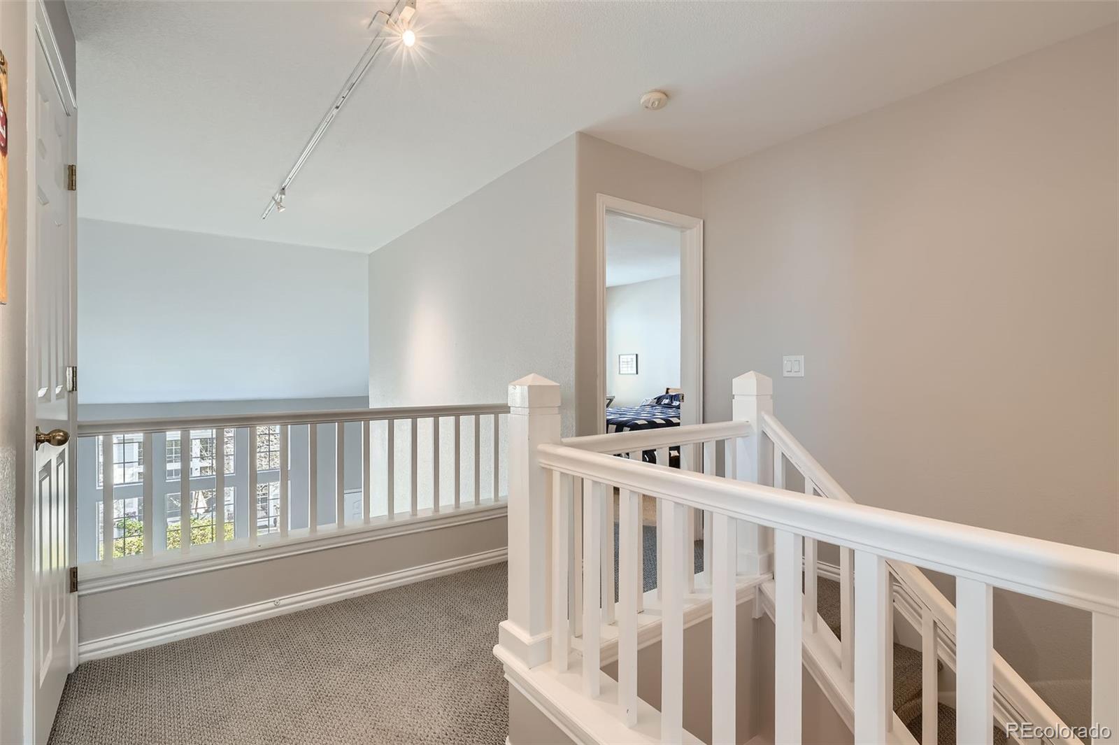 8300 Fairmount Drive, Unit AA102 Denver, CO 80247 - Photo 20 of 27 a view of staircase with white walls