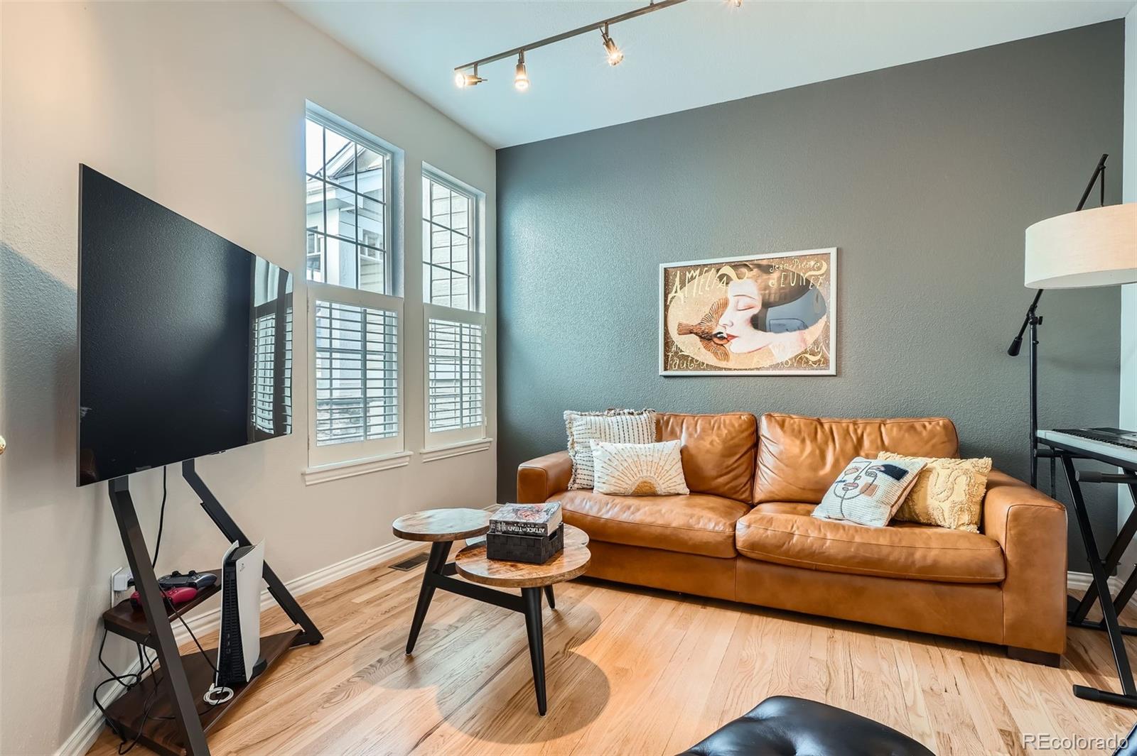 8300 Fairmount Drive, Unit AA102 Denver, CO 80247 - Photo 23 of 27 a living room with furniture and a flat screen tv