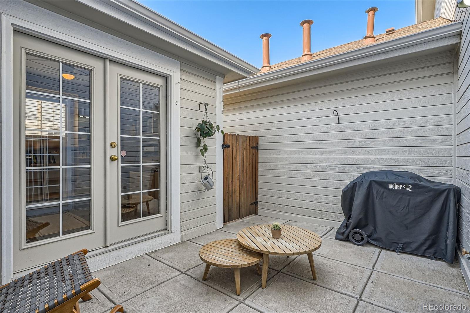 8300 Fairmount Drive, Unit AA102 Denver, CO 80247 - Photo 25 of 27 a front view of a house with outdoor seating