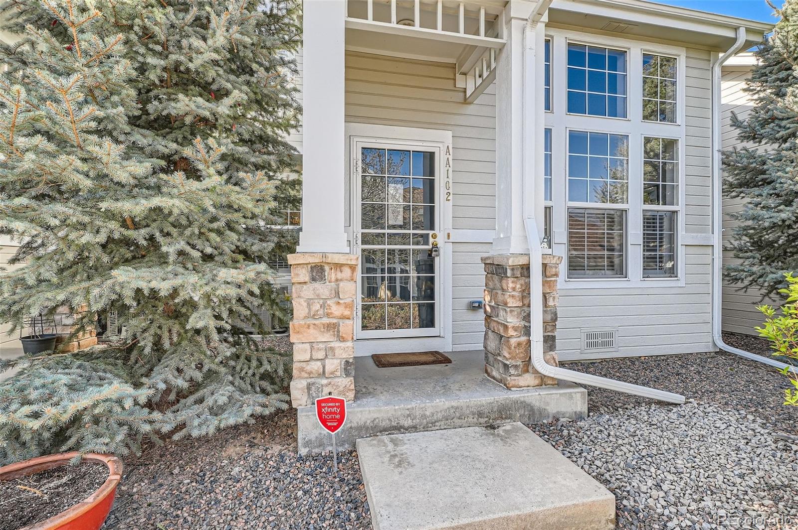 8300 Fairmount Drive, Unit AA102 Denver, CO 80247 - Photo 4 of 27 a front view of a house with a yard