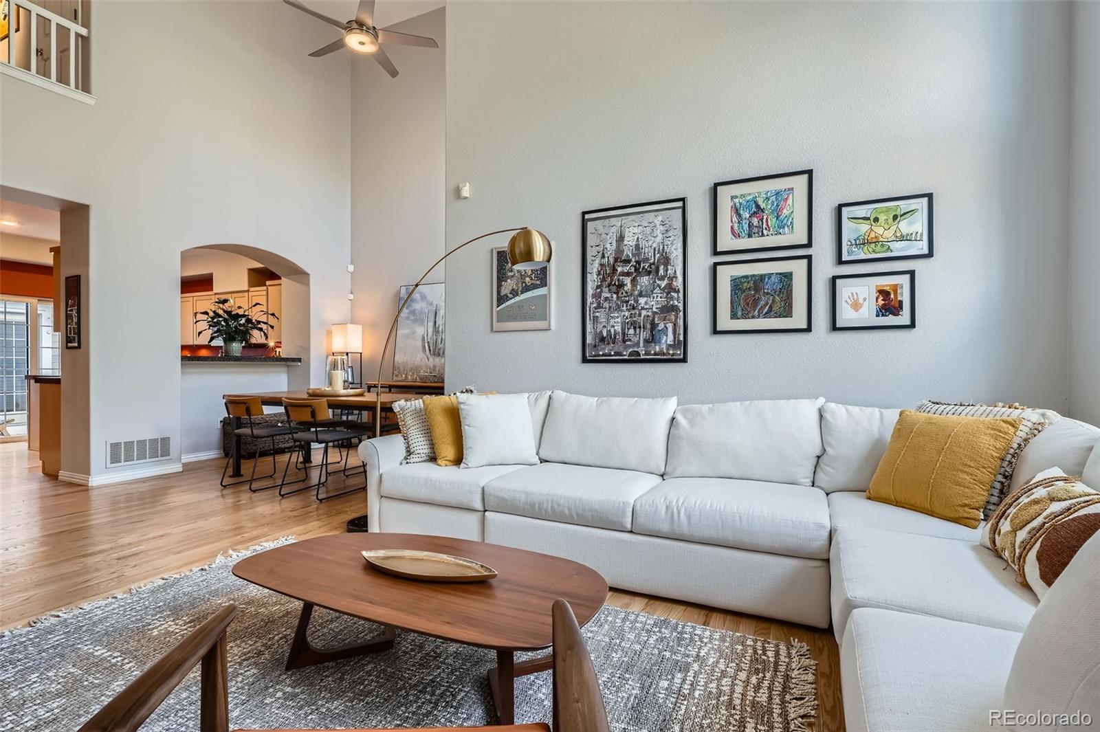 8300 Fairmount Drive, Unit AA102 Denver, CO 80247 - Photo 5 of 27 a living room with furniture and wooden floor