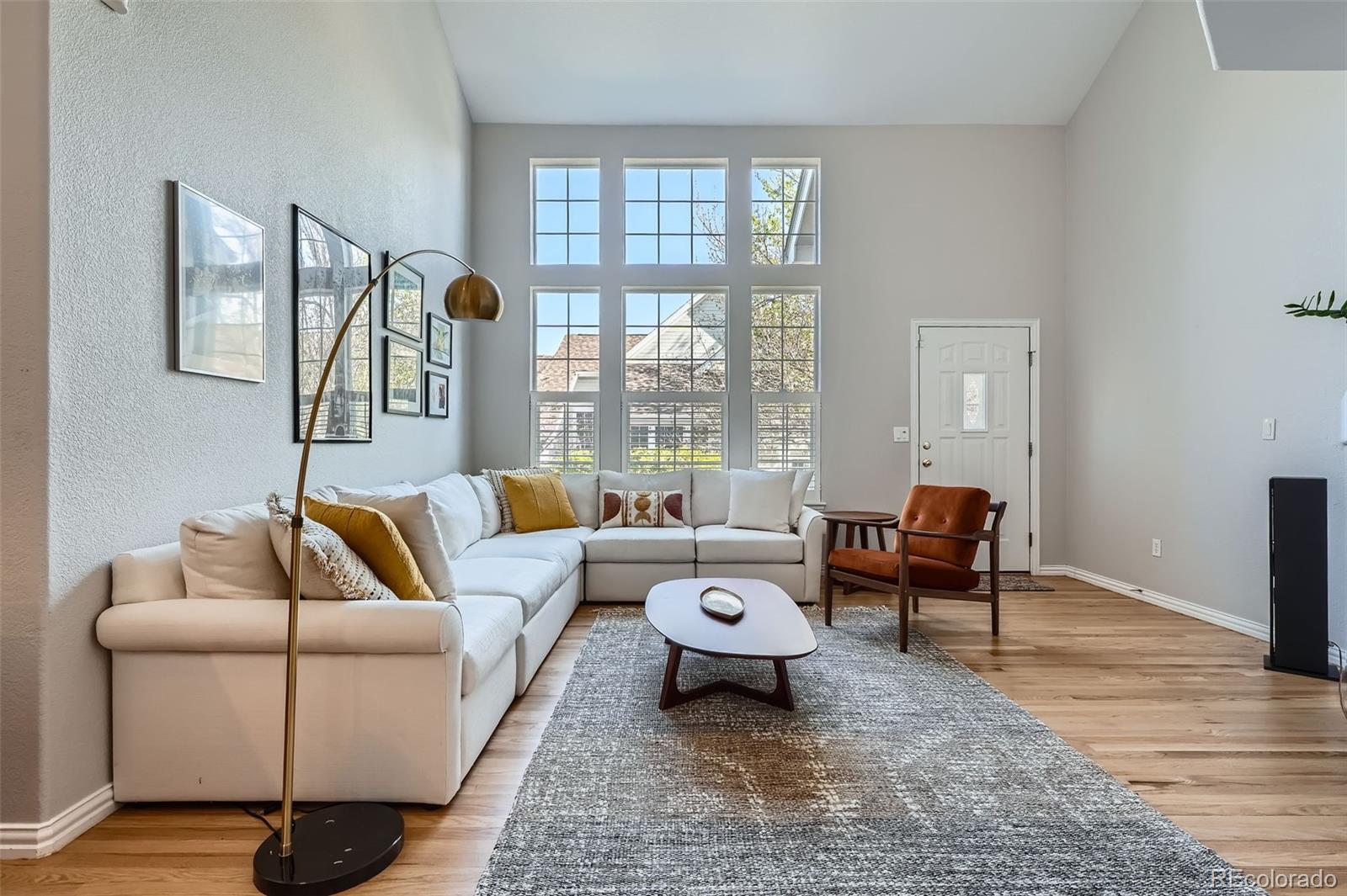 8300 Fairmount Drive, Unit AA102 Denver, CO 80247 - Photo 6 of 27 a living room with furniture and a large window