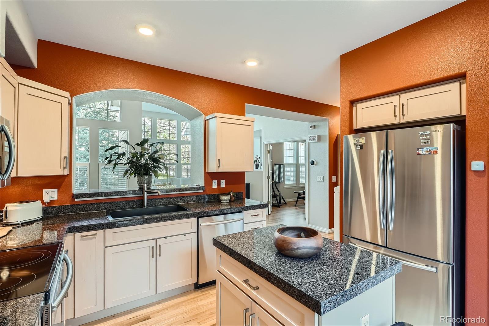8300 Fairmount Drive, Unit AA102 Denver, CO 80247 - Photo 9 of 27 a kitchen with stainless steel appliances granite countertop a sink and a refrigerator
