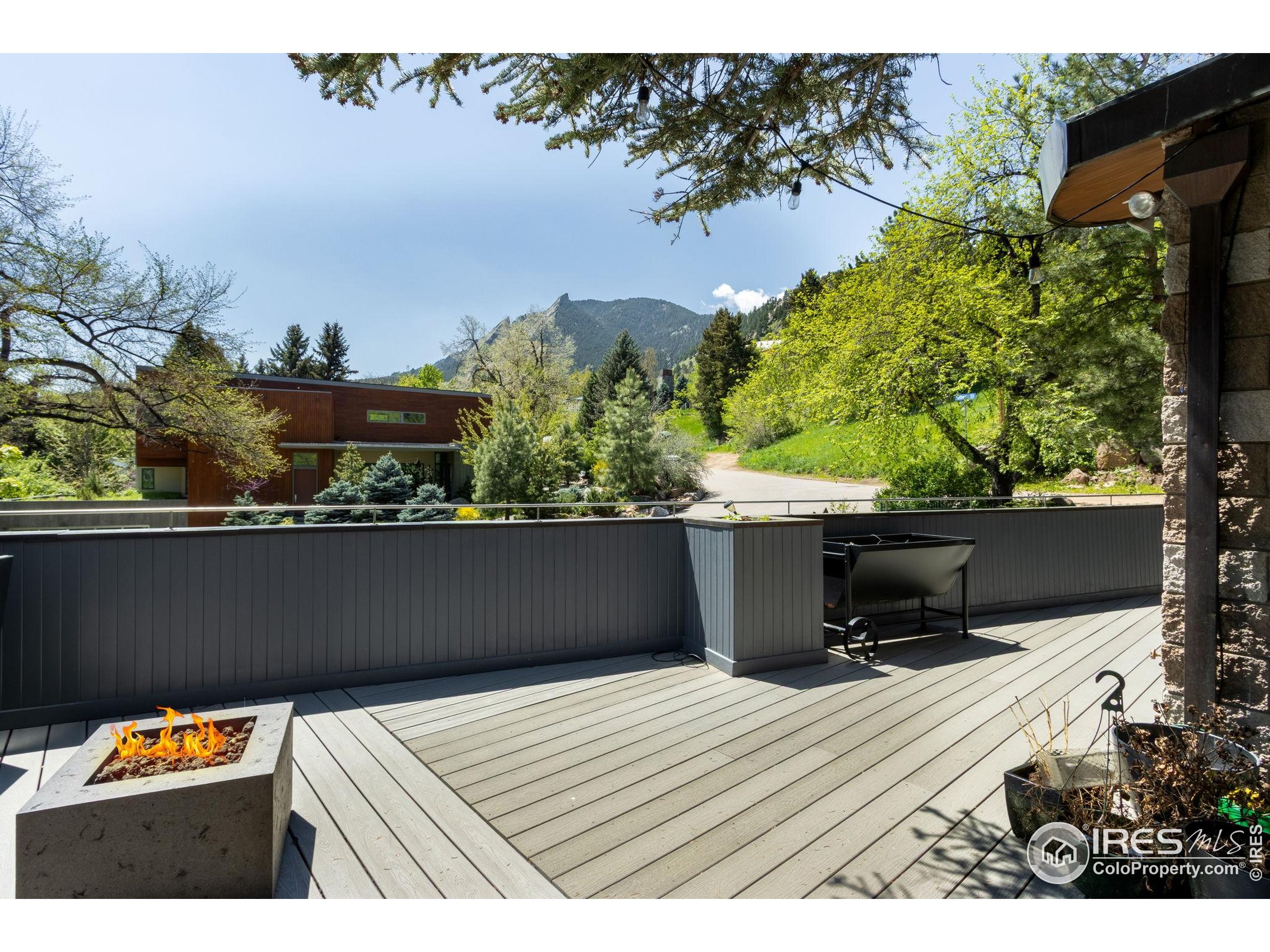 a view of balcony with wooden floor and a garden