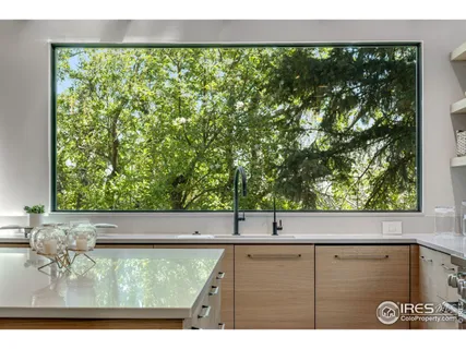 a view of a floor to ceiling window and an outdoor view