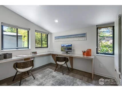 a kitchen with a sink and chairs