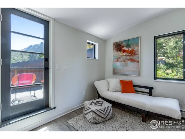 a living room with furniture a window and a flat screen tv